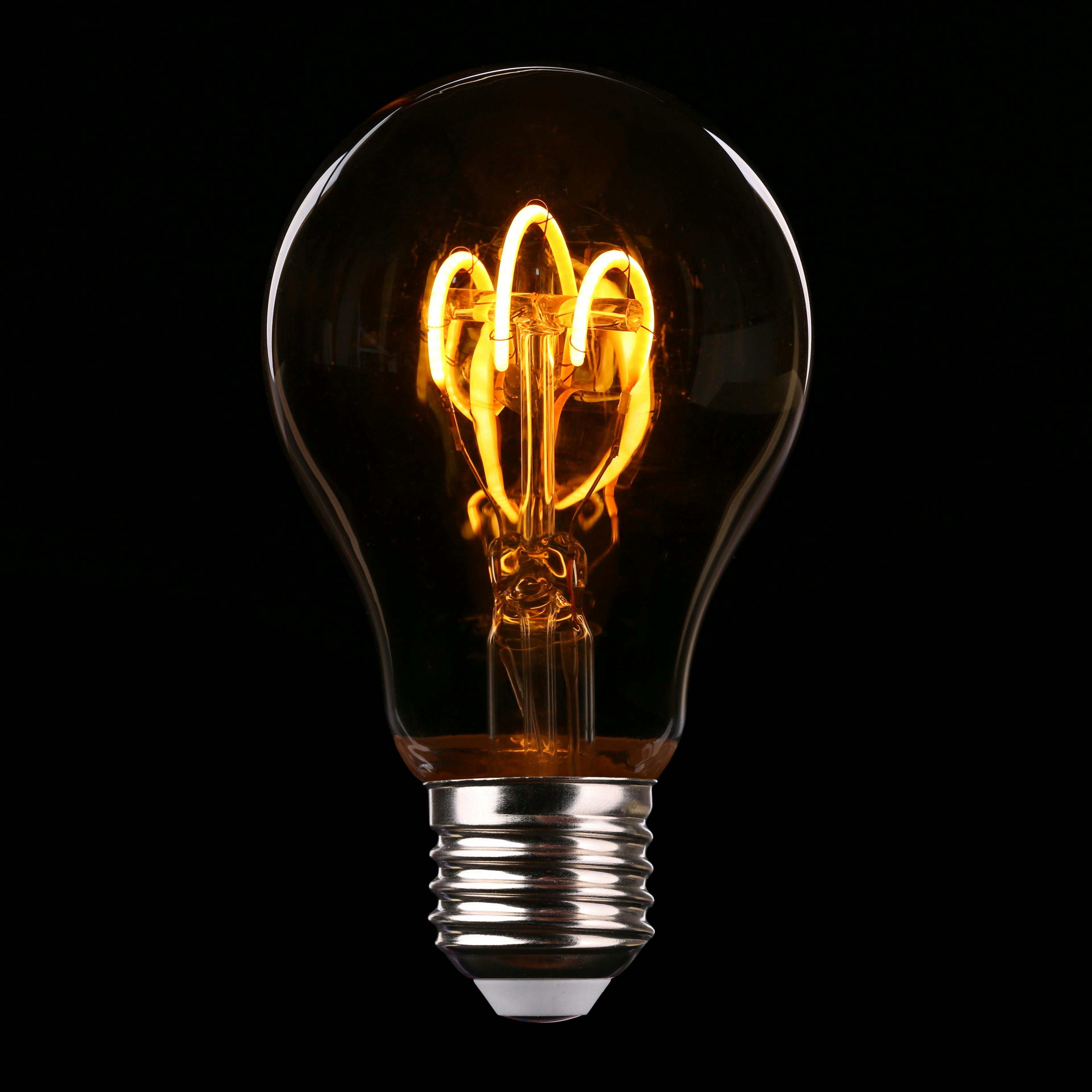 Vintage-style light bulb with filament visible on a black background - from https://www.pexels.com/photo/light-bulb-577514/